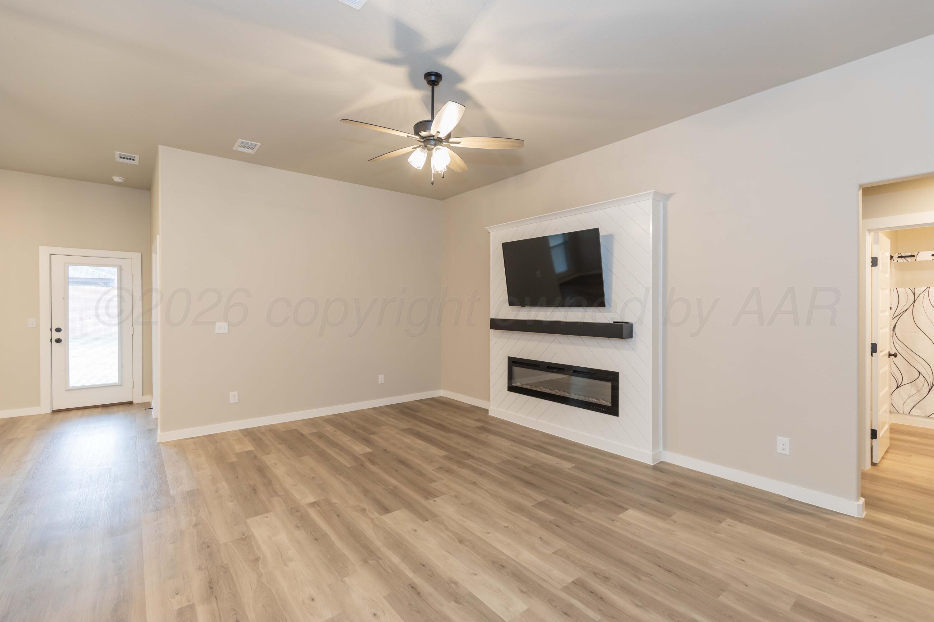 1807 Moon River Road Amarillo, TX 79118 - Photo 7 of 37 a view of an empty room with a fireplace and a window