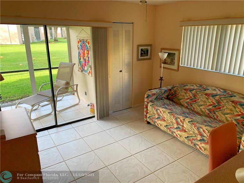 Kings Point Delray Beach, FL 33484 - Photo 16 of 20 a bedroom with a bed and a window