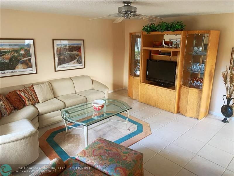 Kings Point Delray Beach, FL 33484 - Photo 5 of 20 a living room with furniture and a flat screen tv