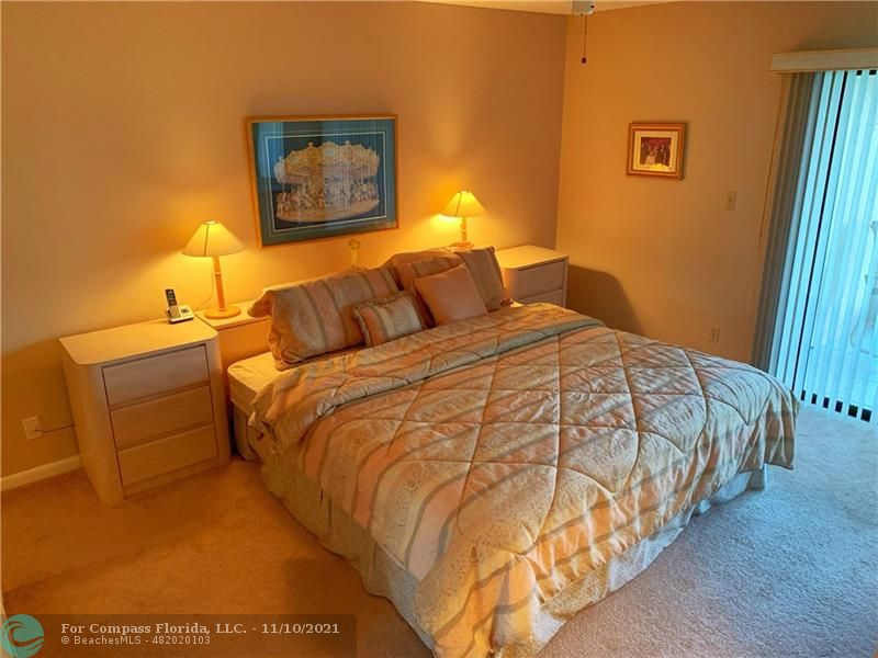 Kings Point Delray Beach, FL 33484 - Photo 10 of 20 a bed sitting in a bedroom next to a window