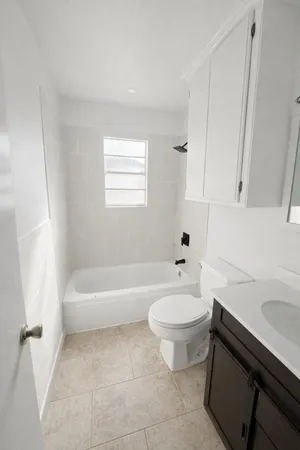 a bathroom with a sink a toilet and bathtub
