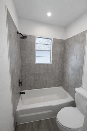 a bathroom with a bathtub and a toilet