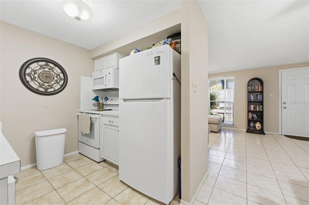 4218 Terrapin Place, Unit D New Port Richey, FL 34652 - Photo 11 of 34 a white refrigerator freezer sitting in a kitchen