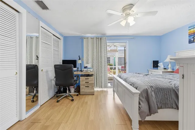 a bedroom with a bed and a desk