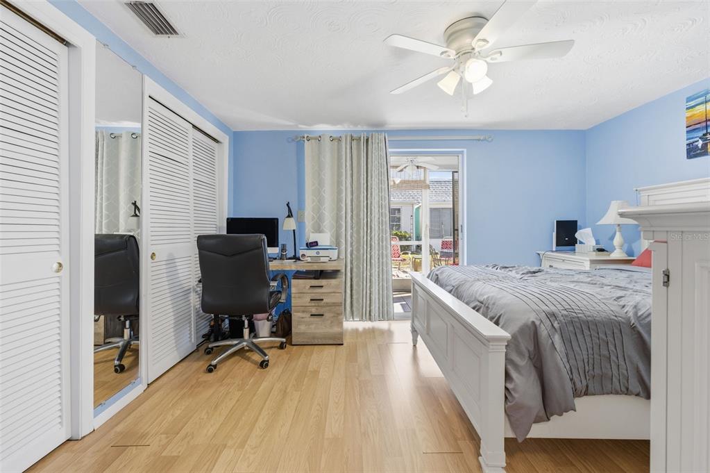 4218 Terrapin Place, Unit D New Port Richey, FL 34652 - Photo 20 of 34 a bedroom with a bed and a desk