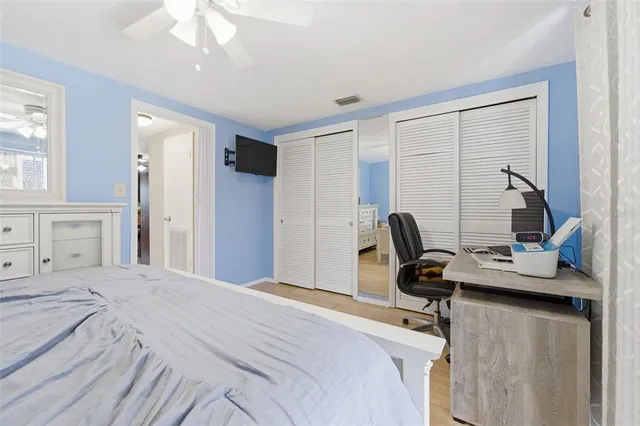 a bedroom with a bed and a desk