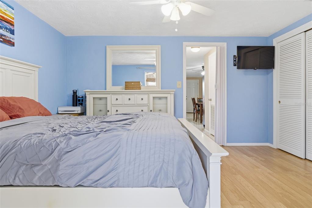 4218 Terrapin Place, Unit D New Port Richey, FL 34652 - Photo 24 of 34 a bedroom with a bed and a flat screen tv