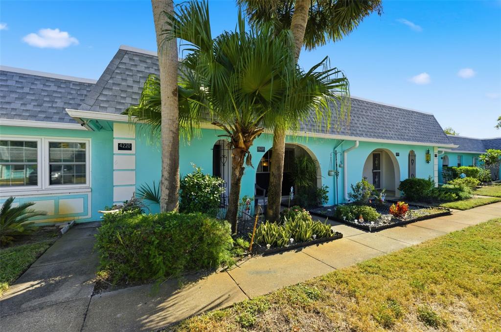 4218 Terrapin Place, Unit D New Port Richey, FL 34652 - Photo 25 of 34 a front view of a house with glass windows and potted plants