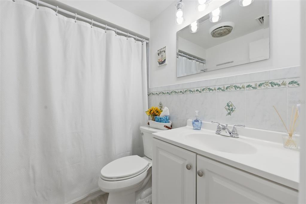 4218 Terrapin Place, Unit D New Port Richey, FL 34652 - Photo 26 of 34 a bathroom with a sink a toilet and a mirror