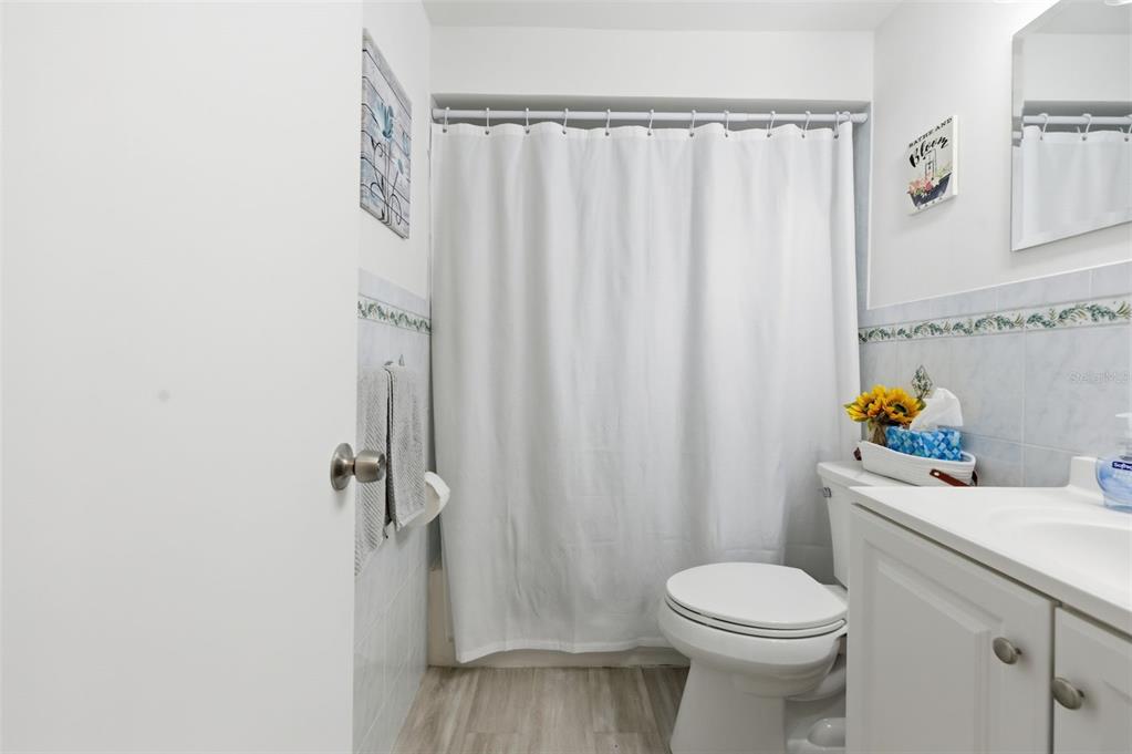 4218 Terrapin Place, Unit D New Port Richey, FL 34652 - Photo 27 of 34 a bathroom with a sink a toilet and shower curtain