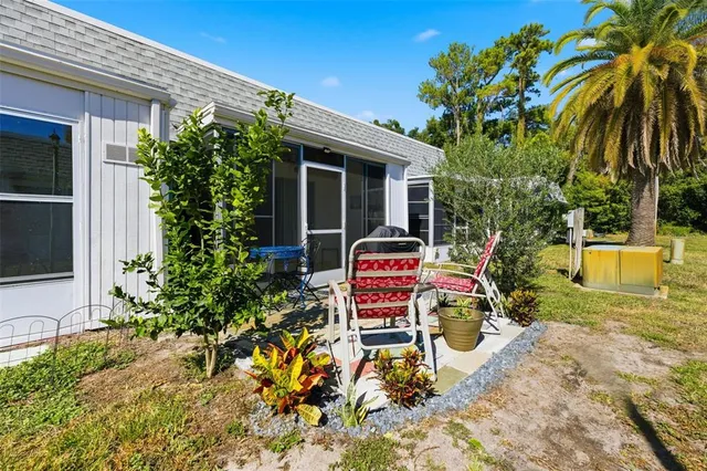 a view of a chair and table in the backyard