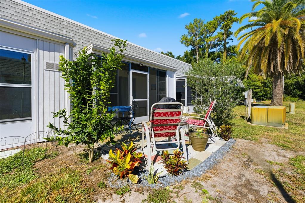 4218 Terrapin Place, Unit D New Port Richey, FL 34652 - Photo 32 of 34 a view of a chair and table in the backyard