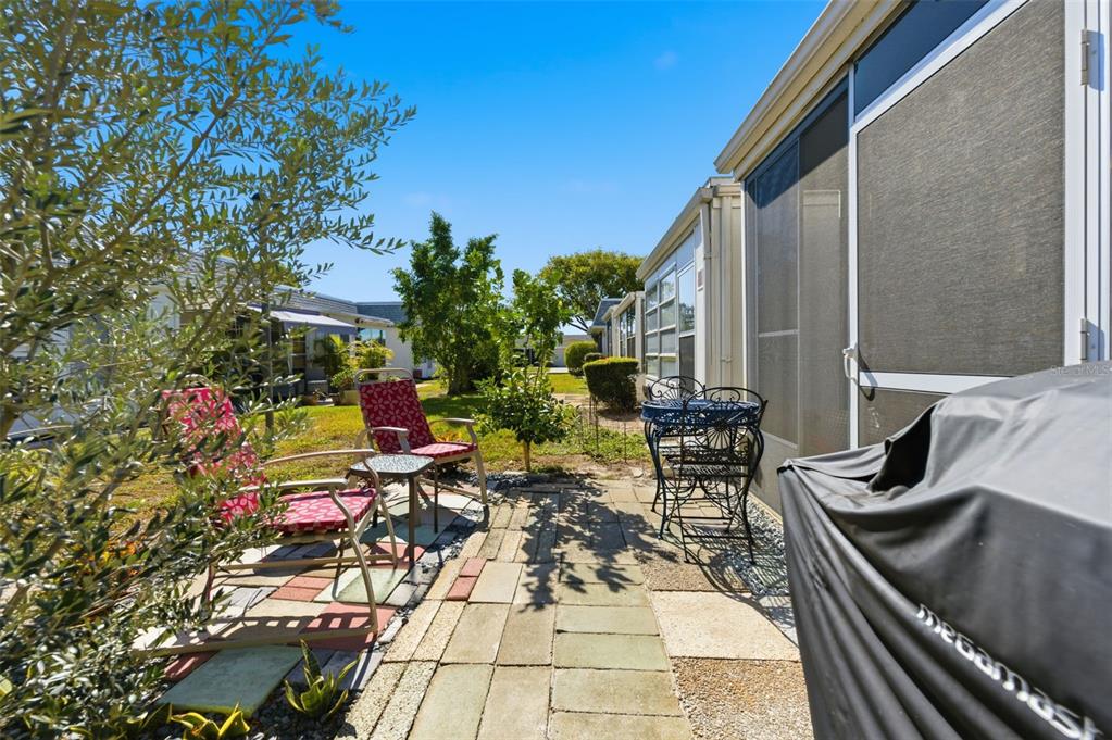 4218 Terrapin Place, Unit D New Port Richey, FL 34652 - Photo 34 of 34 a view of a patio with table and chairs and potted plants