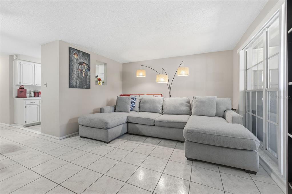 4218 Terrapin Place, Unit D New Port Richey, FL 34652 - Photo 4 of 34 a living room with furniture and a large window