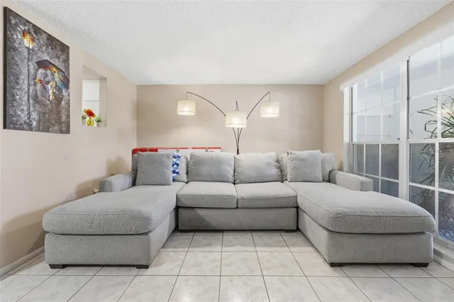 a living room with furniture and a potted plant