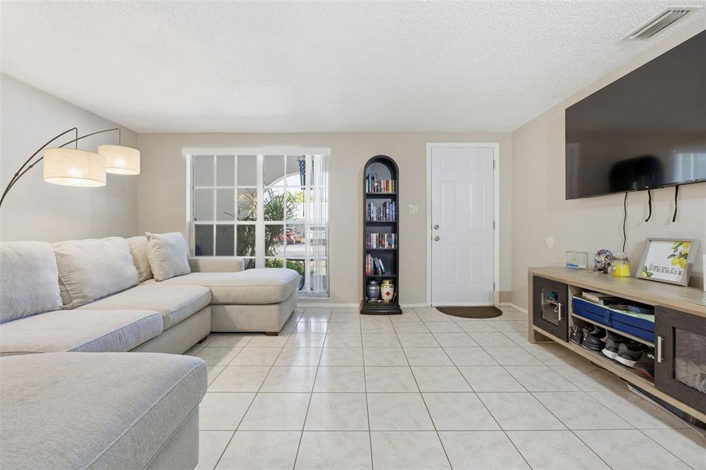 4218 Terrapin Place, Unit D New Port Richey, FL 34652 - Photo 7 of 34 a living room with furniture and a flat screen tv