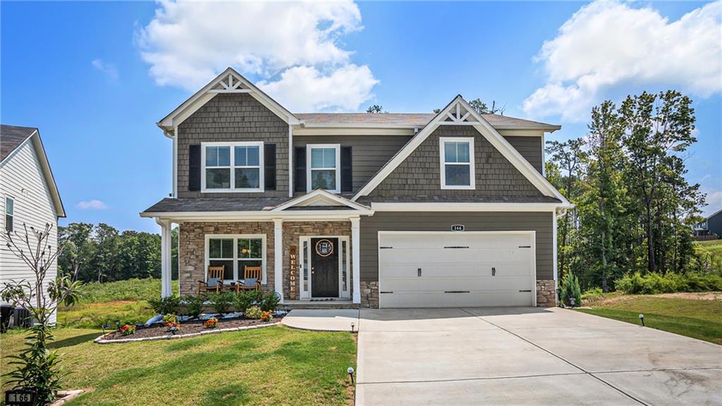 166 Ashbridge Lane Dallas, GA 30132 - Photo 1 of 1 a front view of a house with a yard and garage