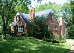 a front view of house with a garden