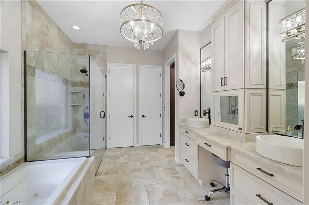 10071 St Moritz Drive Miromar Lakes, FL 33913 - Photo 14 of 45 a bathroom with a double vanity sink mirror double and shower