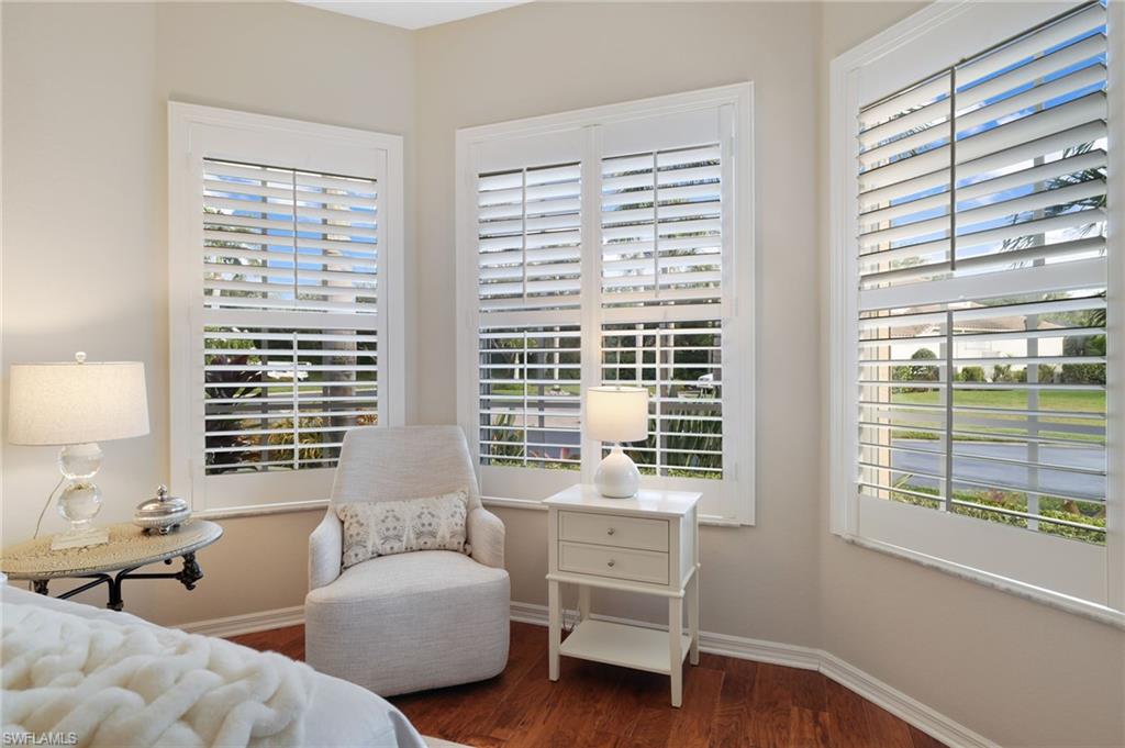 10071 St Moritz Drive Miromar Lakes, FL 33913 - Photo 18 of 45 a bedroom with furniture and a window