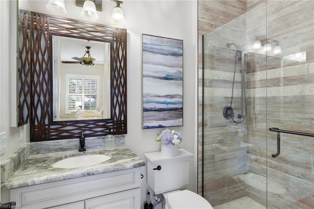 10071 St Moritz Drive Miromar Lakes, FL 33913 - Photo 19 of 45 a bathroom with a granite countertop sink toilet and shower