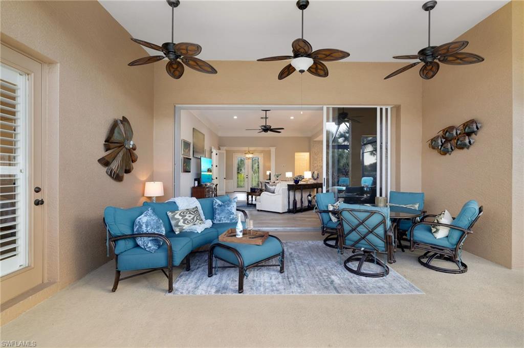 10071 St Moritz Drive Miromar Lakes, FL 33913 - Photo 21 of 45 a living room with furniture and a chandelier