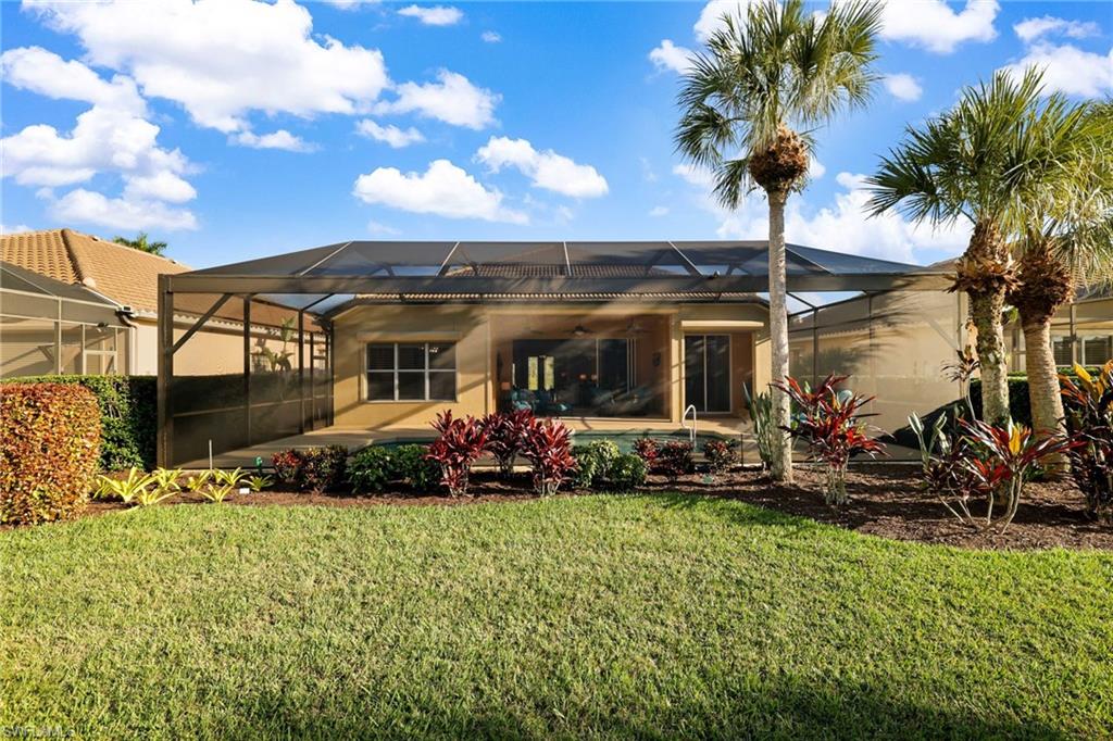 10071 St Moritz Drive Miromar Lakes, FL 33913 - Photo 27 of 45 a front view of a house with garden