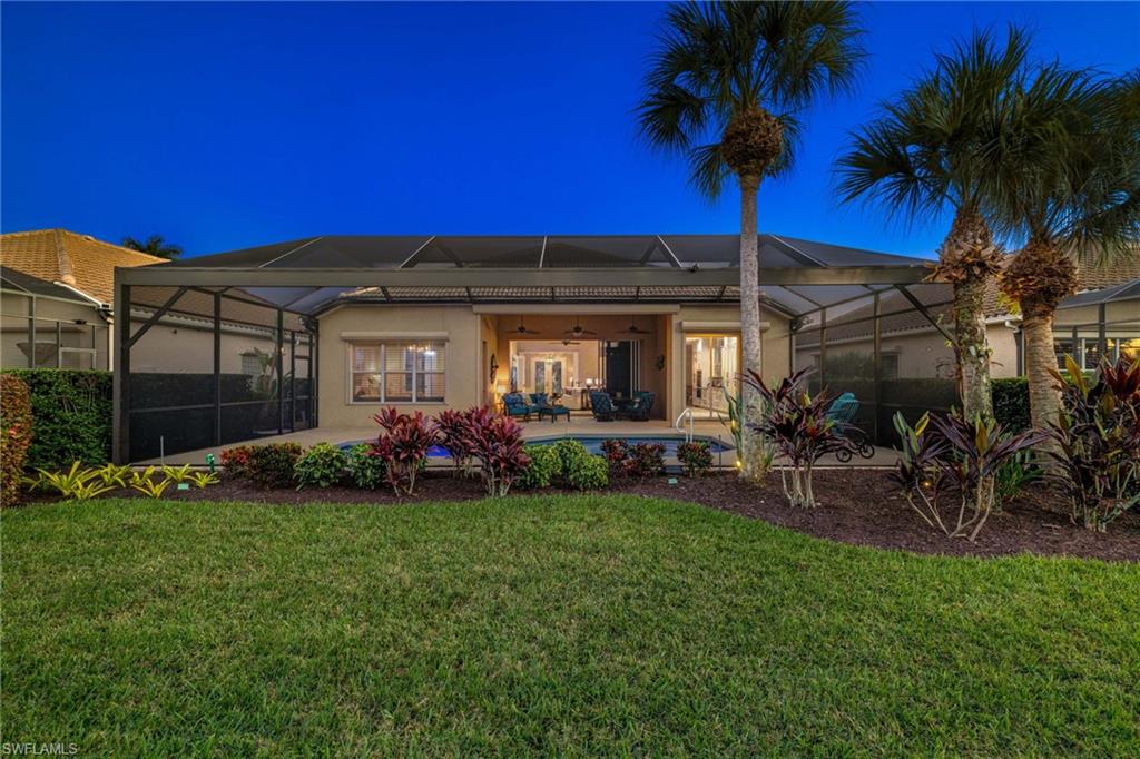 10071 St Moritz Drive Miromar Lakes, FL 33913 - Photo 29 of 45 a view of a house with a yard