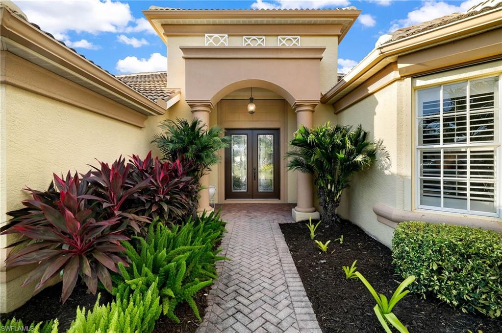 10071 St Moritz Drive Miromar Lakes, FL 33913 - Photo 30 of 45 a front view of a house with a porch