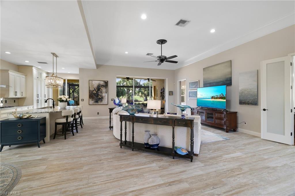 10071 St Moritz Drive Miromar Lakes, FL 33913 - Photo 4 of 45 a living room with furniture and a wooden floor