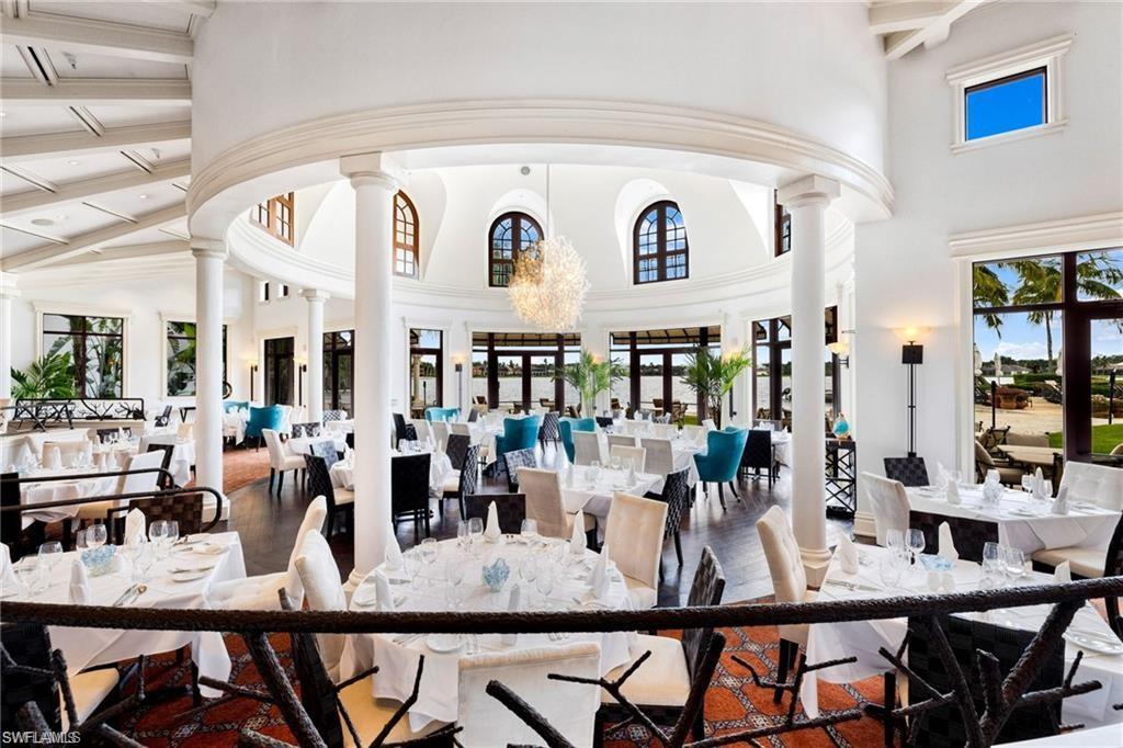 10071 St Moritz Drive Miromar Lakes, FL 33913 - Photo 44 of 45 a view of a dining room with furniture and wooden floor