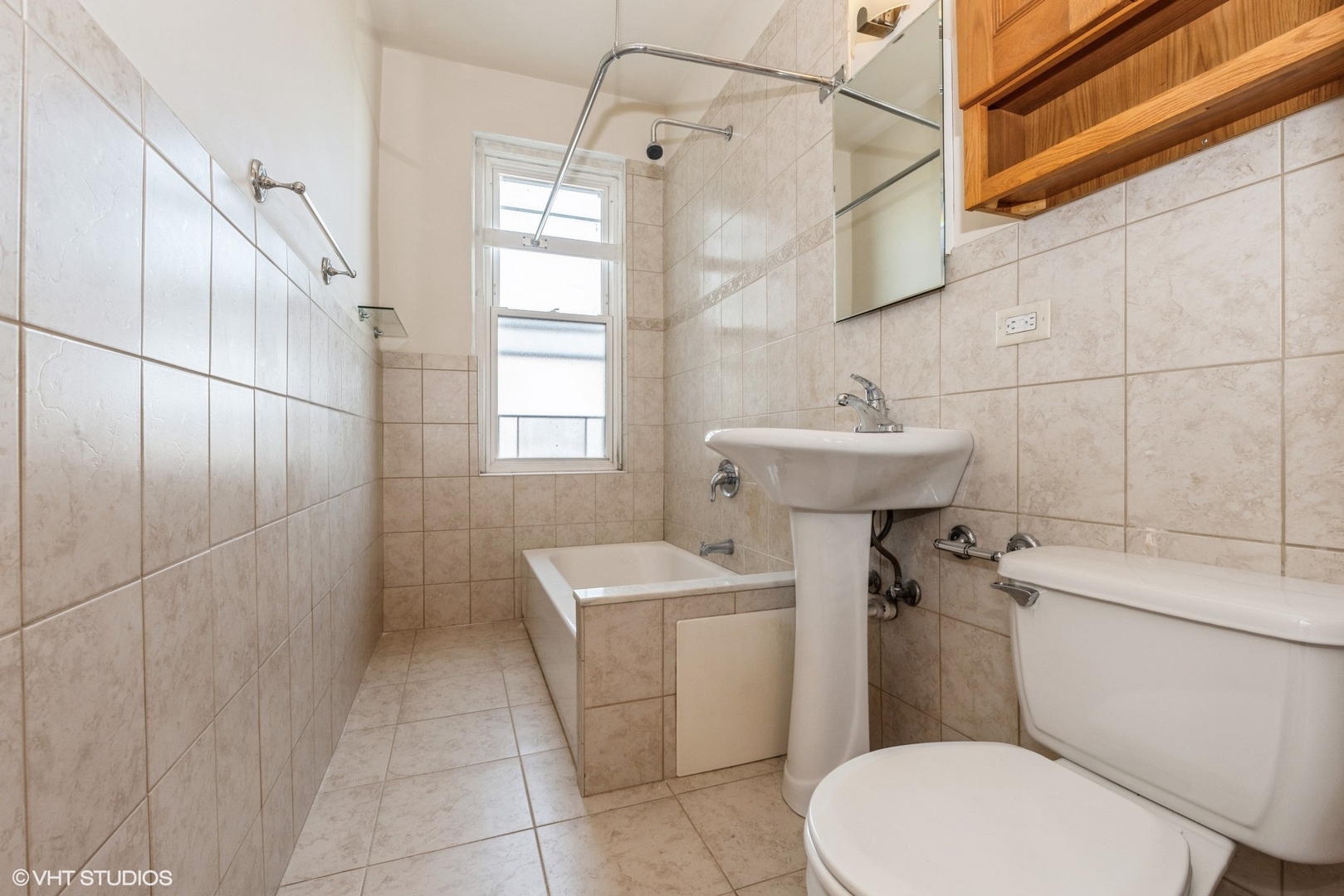 6334 North Sheridan Road, Unit 4C Chicago, IL 60660 - Photo 12 of 13 a bathroom with a sink a toilet and shower