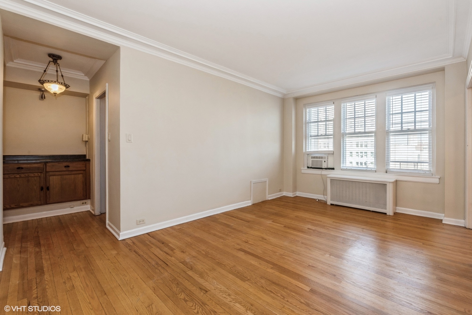 6334 North Sheridan Road, Unit 4C Chicago, IL 60660 - Photo 7 of 13 wooden floor in an empty room with a window