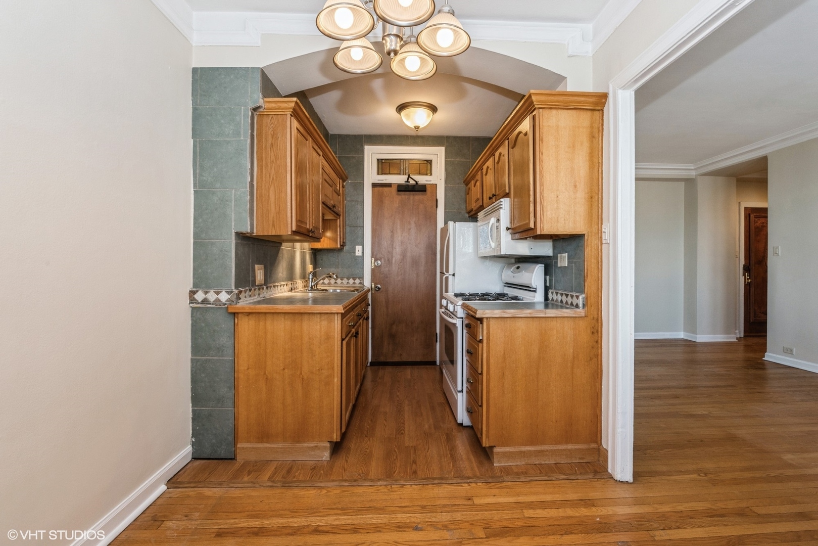6334 North Sheridan Road, Unit 4C Chicago, IL 60660 - Photo 9 of 13 a kitchen with counter top space cabinets and stainless steel appliances