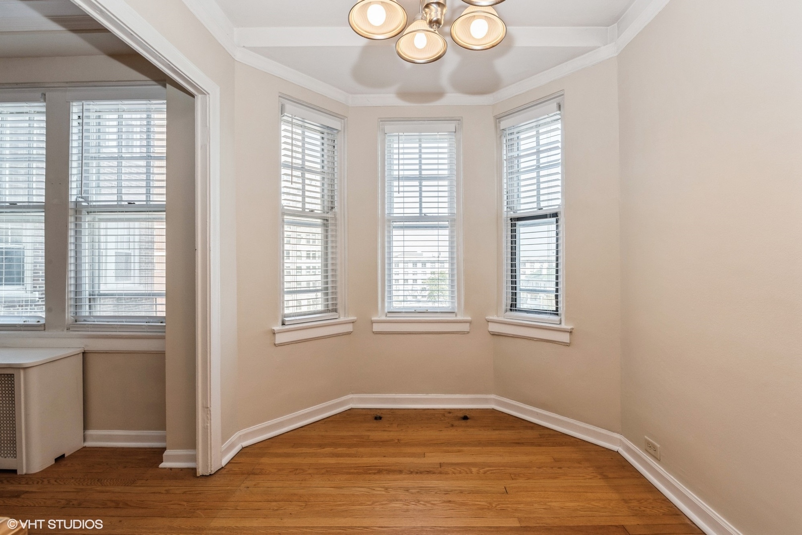 6334 North Sheridan Road, Unit 4C Chicago, IL 60660 - Photo 10 of 13 a view of an empty room with wooden floor and a window