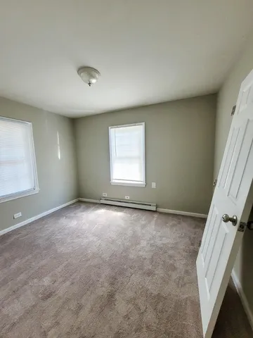 an empty room with a empty space and windows