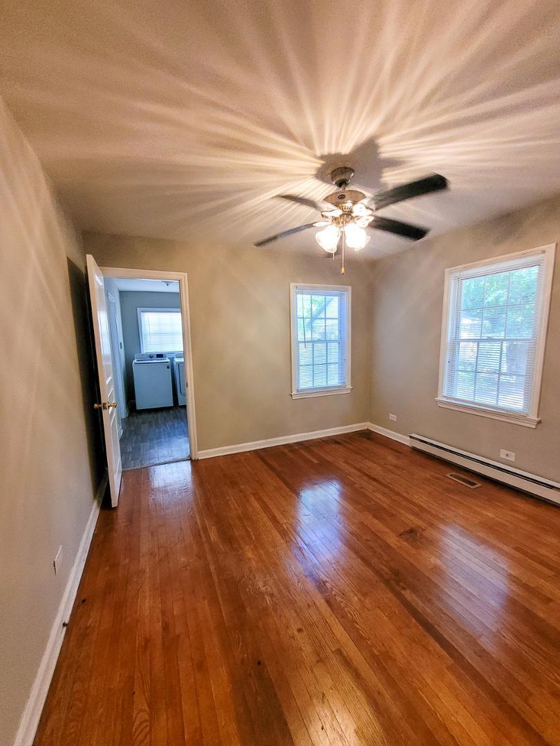 2309 East Main Street Durham, NC 27703 - Photo 25 of 30 a view of empty room with wooden floor and fan