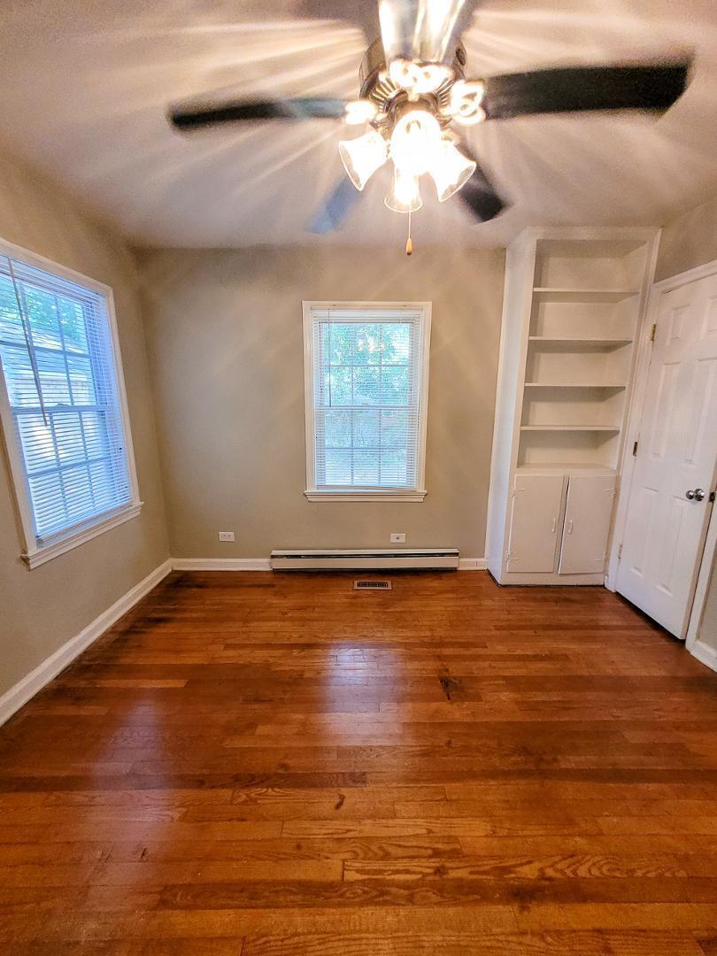 2309 East Main Street Durham, NC 27703 - Photo 27 of 30 a view of an empty room with wooden floor and a window