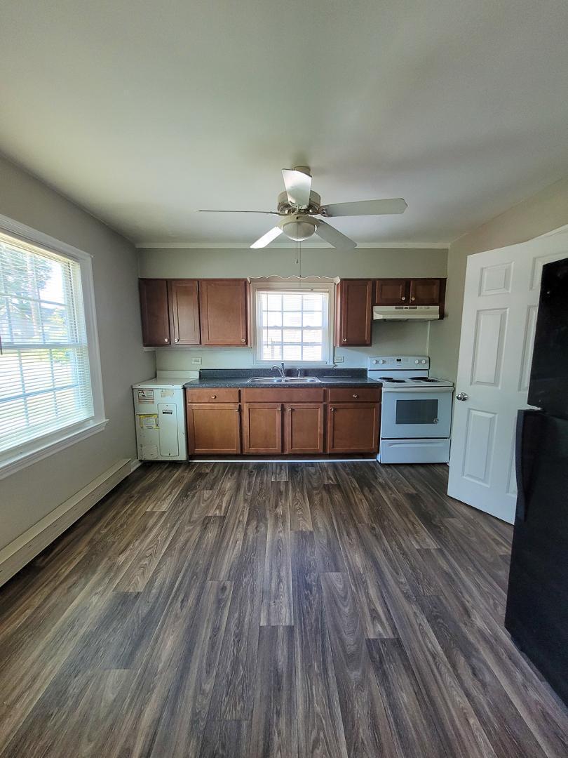 2309 East Main Street Durham, NC 27703 - Photo 6 of 30 a kitchen with wooden floors and wooden cabinets