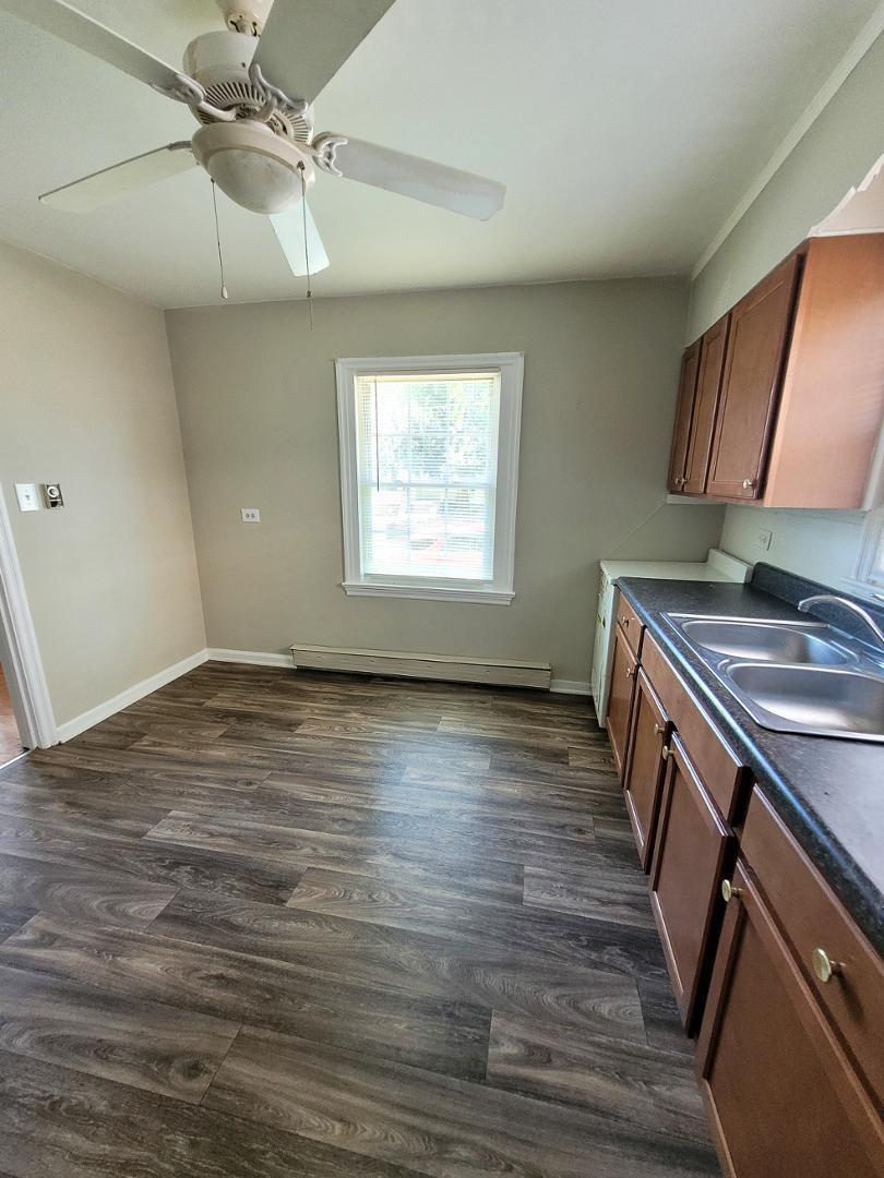 2309 East Main Street Durham, NC 27703 - Photo 8 of 30 an empty room with wooden floor fan and windows