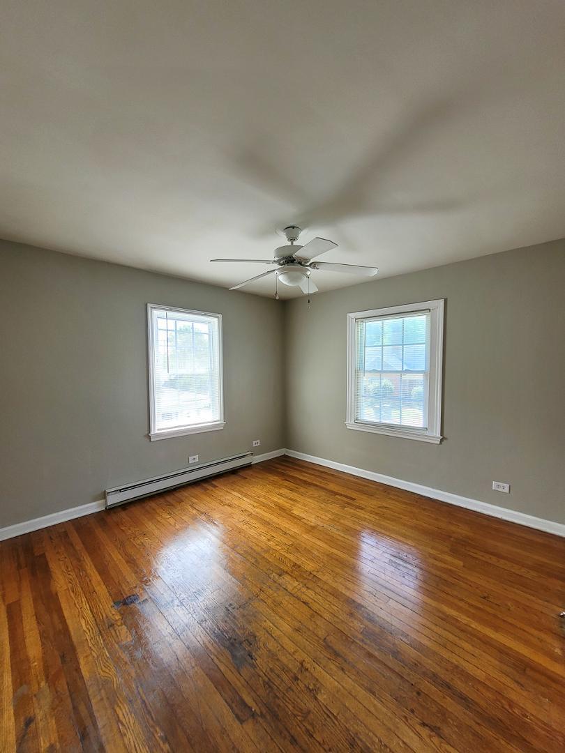 2309 East Main Street Durham, NC 27703 - Photo 10 of 30 an empty room with wooden floor chandelier and windows