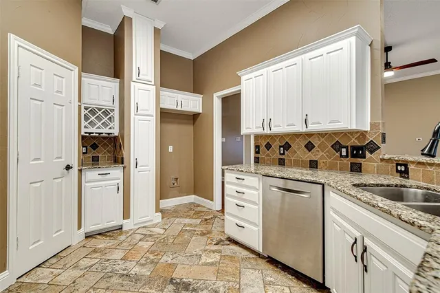 a kitchen with white cabinets and refrigerator