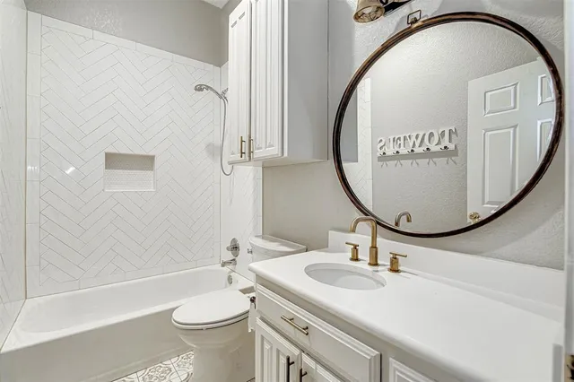 a bathroom with a sink a toilet and a mirror