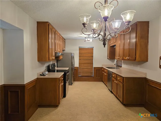 a spacious bathroom with a sink double vanity granite and a mirror
