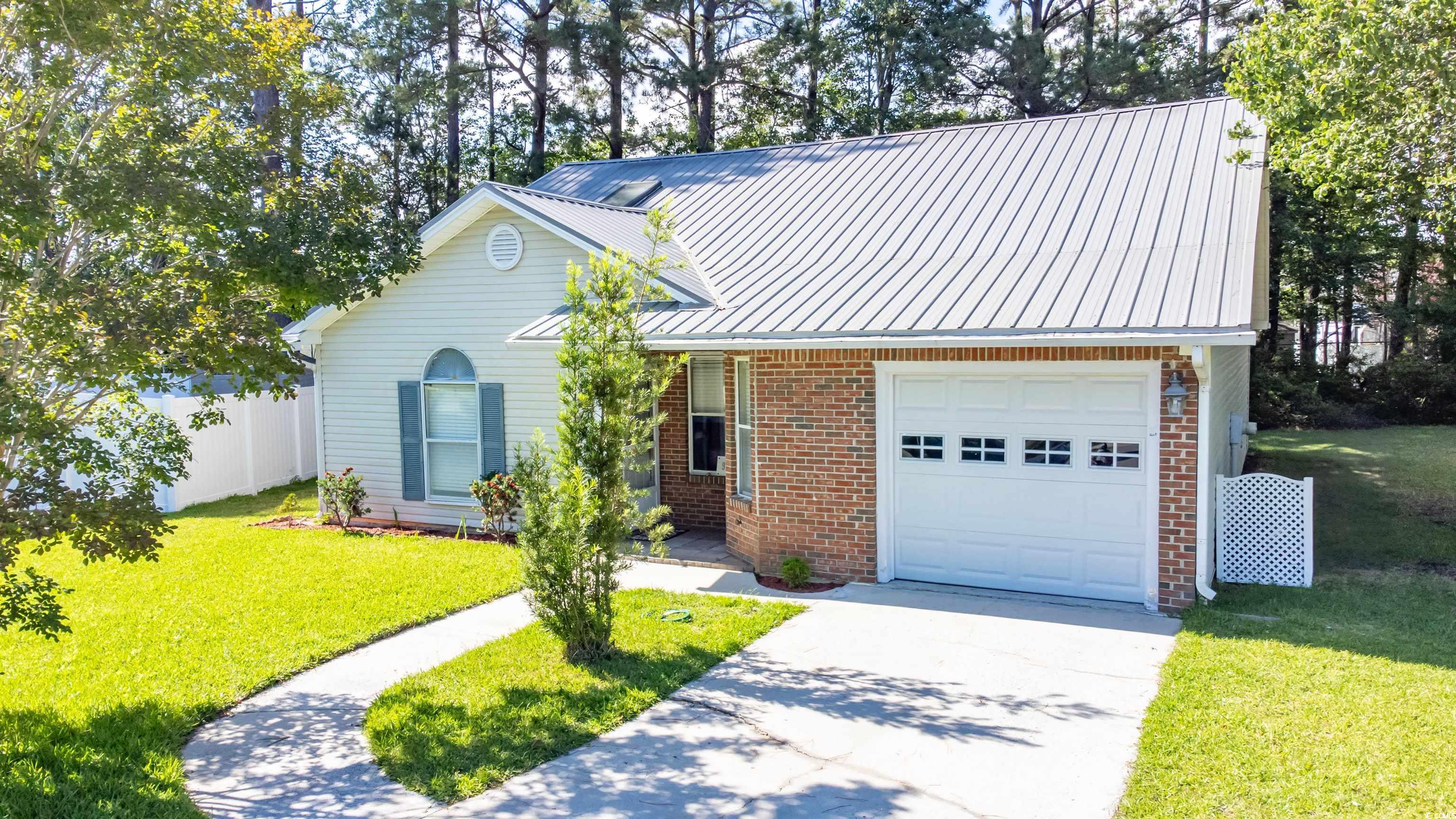 9664 Middleton Court Murrells Inlet, SC 29576 - Photo 1 of 28 Traditional home with an attached garage, brick si
