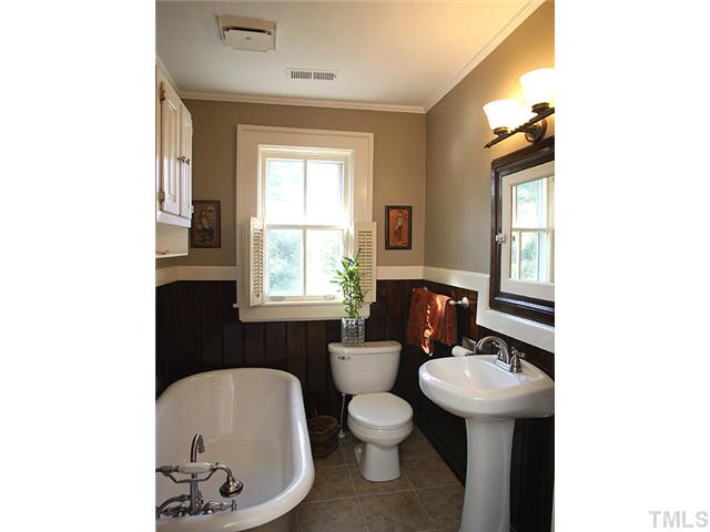 502 Harding Street Raleigh, NC 27604 - Photo 13 of 25 a bathroom with a toilet sink and mirror