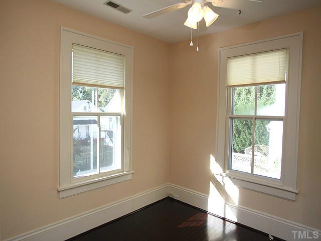 502 Harding Street Raleigh, NC 27604 - Photo 16 of 25 a view of an empty room with wooden floor and a window