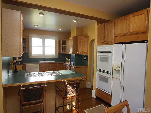 502 Harding Street Raleigh, NC 27604 - Photo 9 of 25 a kitchen with a refrigerator and a sink