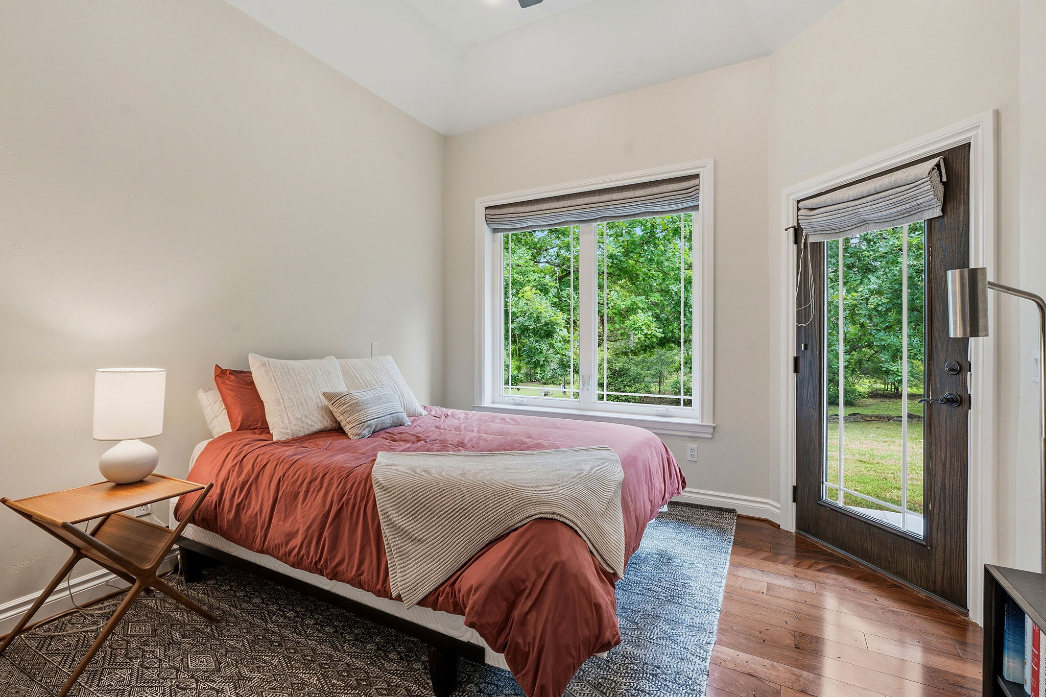 8121 Bluff Trail Austin, TX 78737 - Photo 20 of 40 Hardwood floors and generous windows provide a serene, nature-filled escape in this cozy sleeping area.