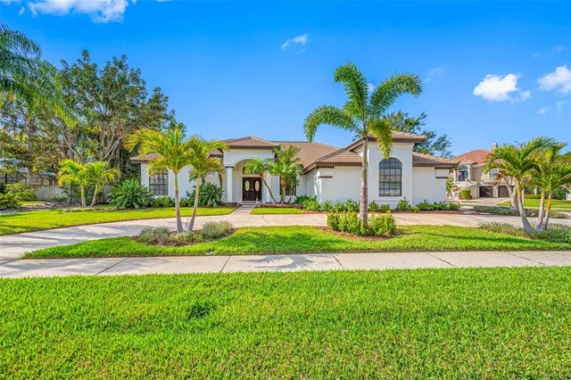 a view of a fountain in front of a house with a big yard